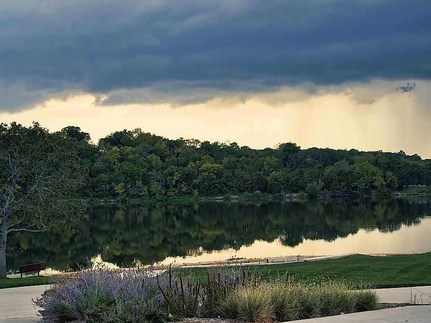 A large thunderstorm forming at Lake Olathe over the forest in Olathe, Kansas