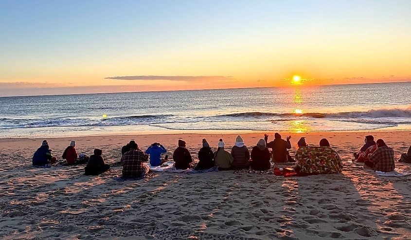 Group of friends gathering for a beach sunrise on New Years Eve on Assateague island, Berlin, Maryland.