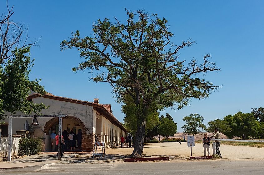  The entrance bell with tourists visiting the mission at the San Juan Bautista State Historic Park