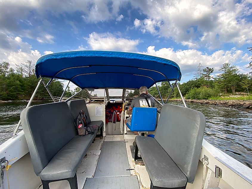 A man driving a boat between islands in Georgian Bay