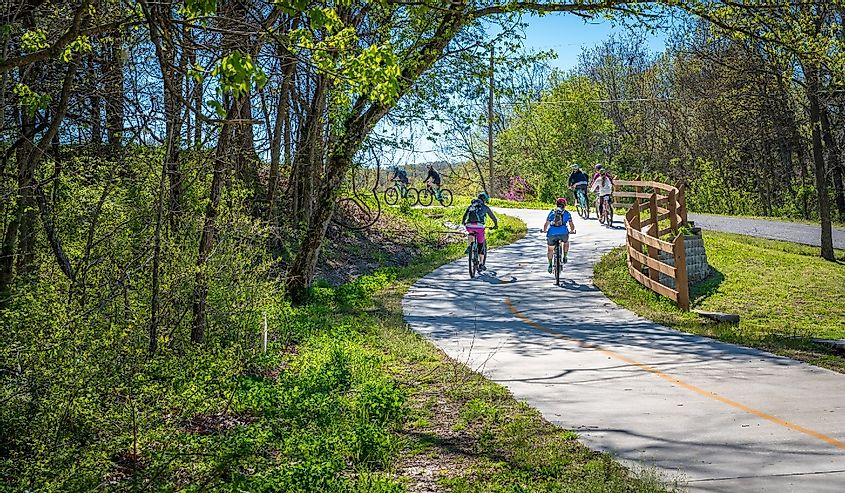 Family with kids biking on bike trail in Bella Vista, Northwest Arkansas