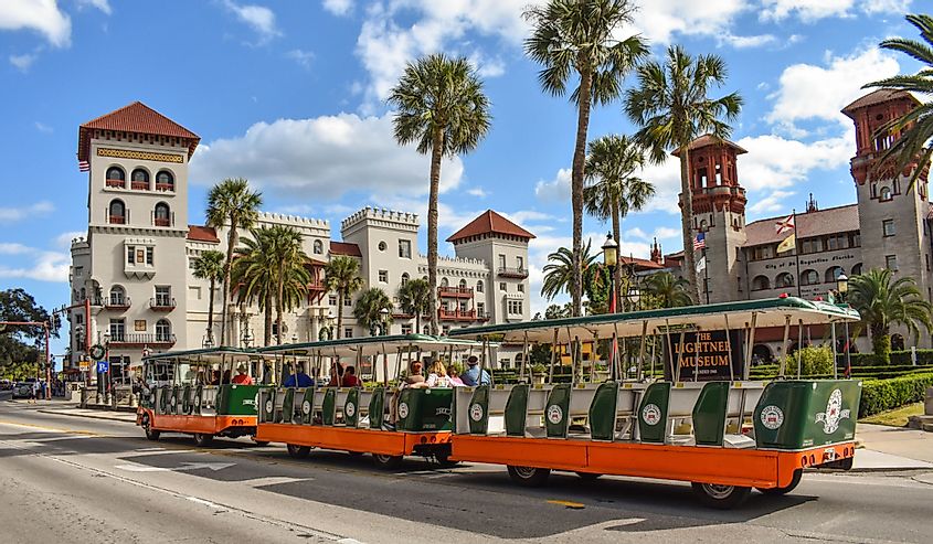 Trolley Tour, Casa Monica Hotel and Lightner Museum on lightblue cloudy sky background at St. Augustine Florida's