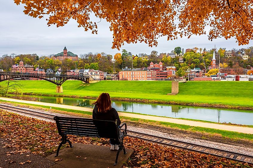 A woman sitting on a chair in Grant Park during autumn in Galena, Illinois