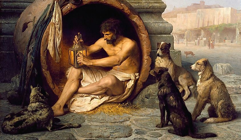 The Greek philosopher Diogenes (404-323 BC) is seated in his abode, the earthenware tub, in the Metroon, Athens, lighting the lamp in daylight with which he was to search for an honest man. His companions were dogs that also served as emblems of his "Cynic" (Greek: "kynikos," dog-like) philosophy, which emphasized an austere existence. 