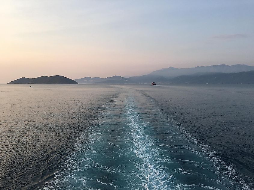 The wake of a ferry boat leaving an island in the Mediterranean. 