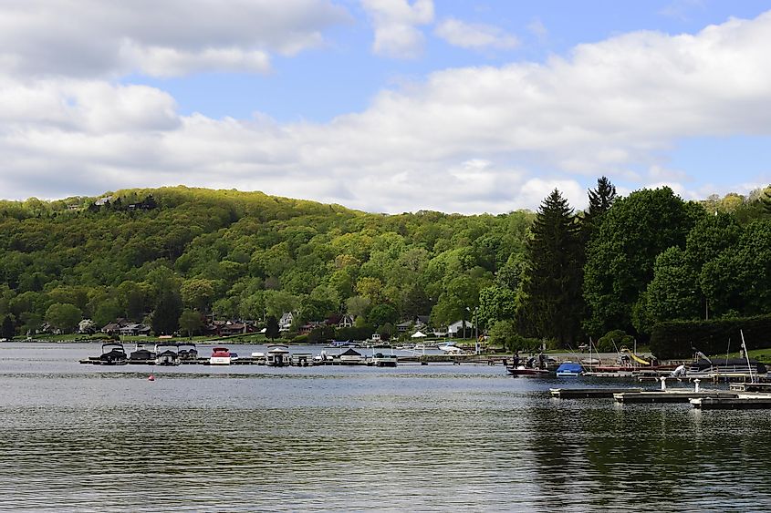 Candlewood Lake on a peaceful summer morning with boats docked and mountainside in background