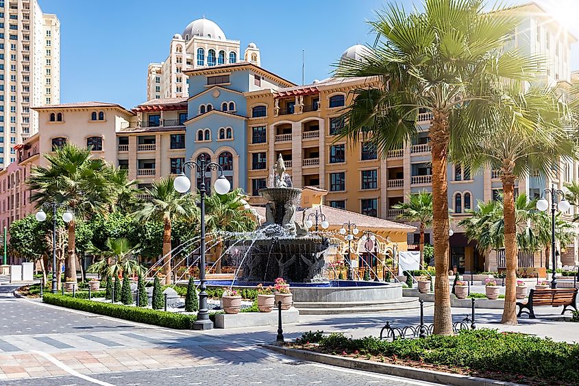 Public square with water fountain on the Medina Centrale district at the Pearl in Doha, Qatar