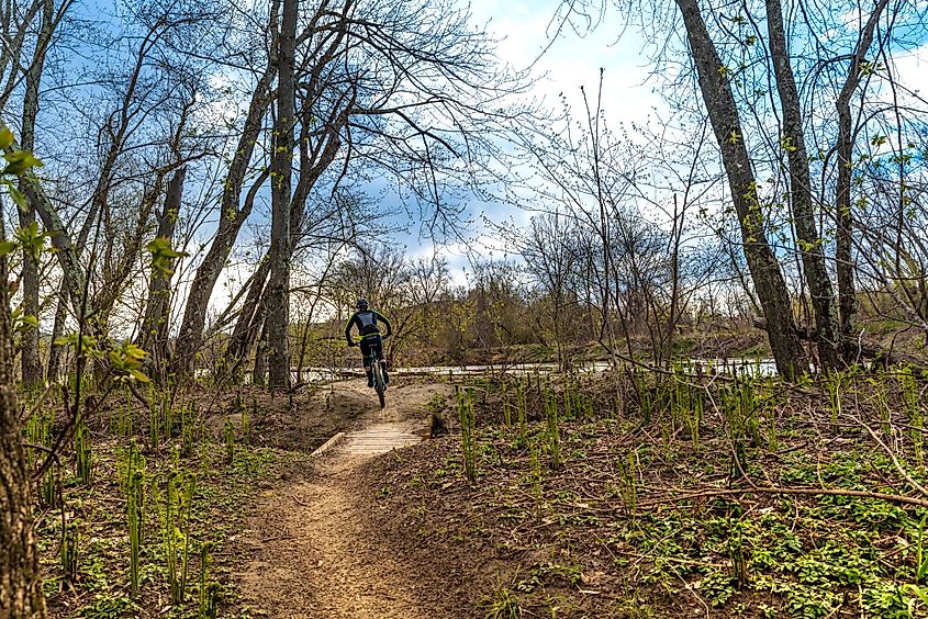 A bike rider on the Warren & Ruth Beeken Rivershore Trail along the Winooski River in Richmond, Vermont