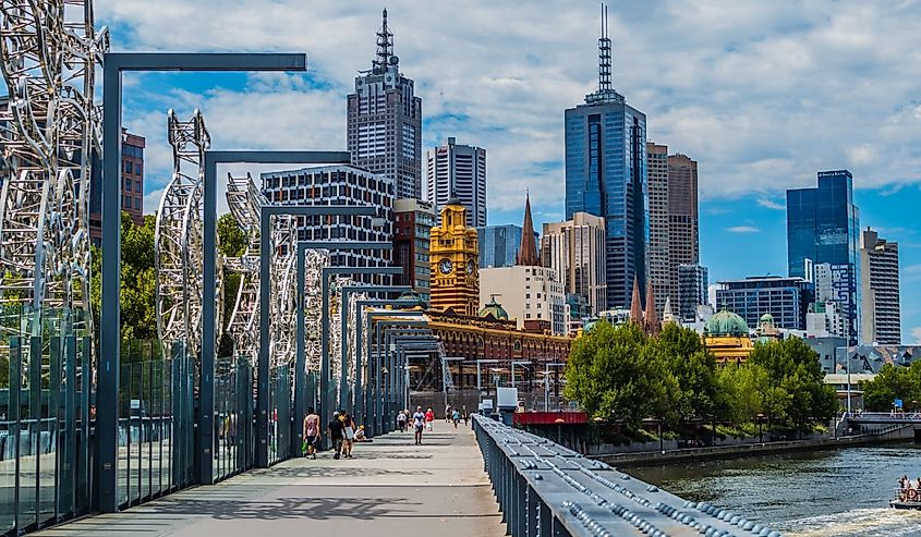 Melbourne downtown with people walking along the water