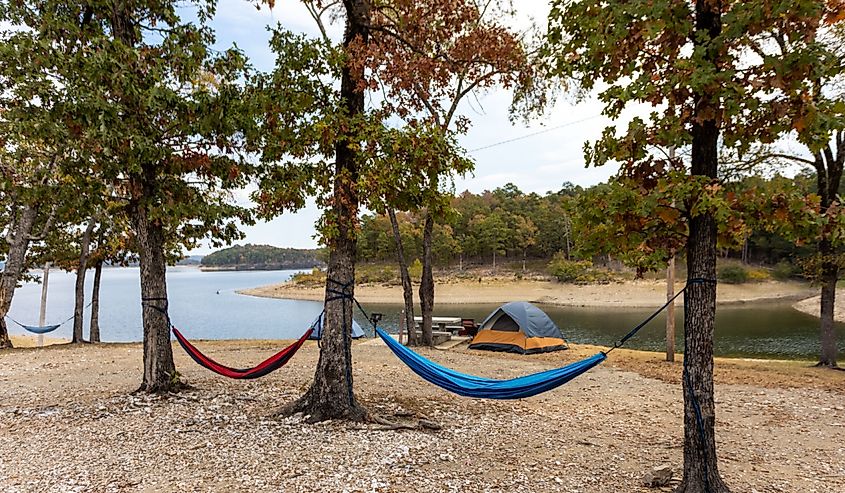 Camping tents and hammock near a beautiful lake among trees, campsite, adventure vacation concept, Broken bow lake in Oklahoma