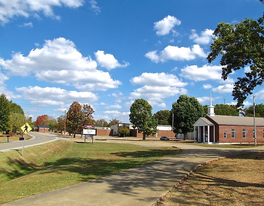 Buildings along State Route 11 in Minor Hill, Tennessee, with First Baptist Church on the right and Minor Hill School in the background