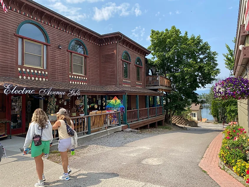 Two women walk past an old-timey shop called Electric Avenue Gifts.