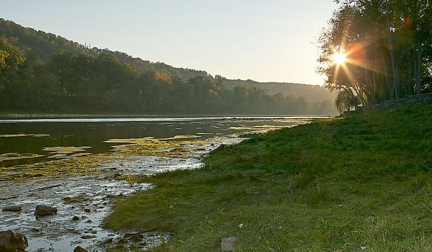 Star burst sun over the White River, Arkansas with early morning mist in a tranquil scenic landscape