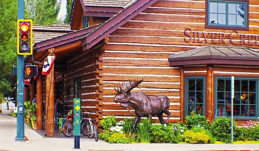 Downtown Ketchum Idaho street corner with log cabin store and moose sculpture near Sun Valley -Last home and burying place of Ernest Hemingway