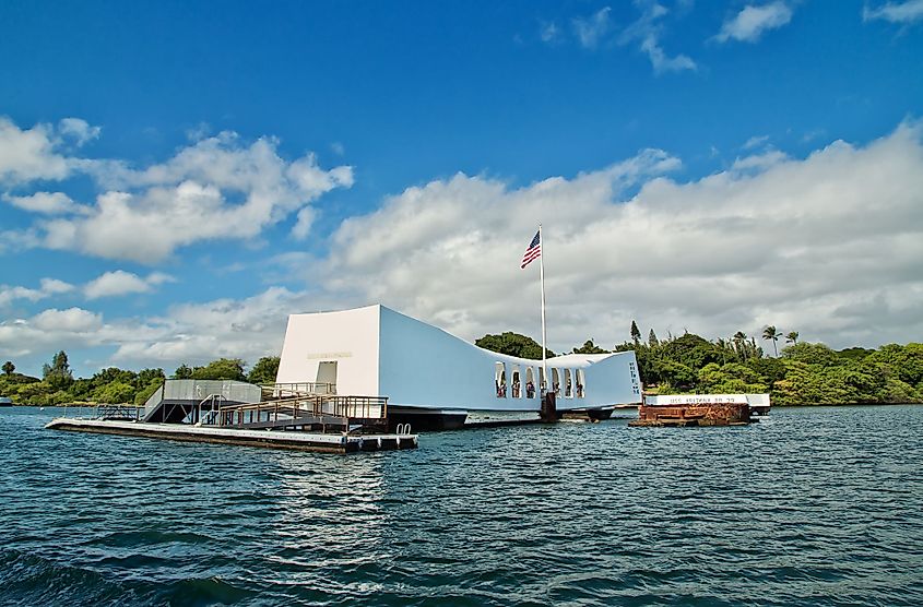 Visitors look out from the memorial sited over the wreck of battleship USS Arizona