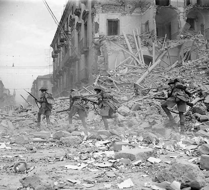 More details British troops scramble over rubble in a devastated street in Catania, Sicily, 5 August 1943