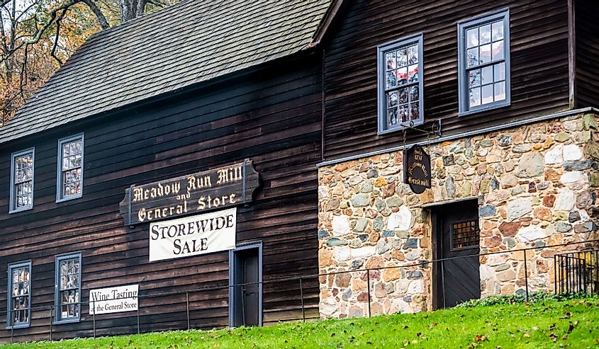 Meadow run mill and general store building architecture with sign for wine tasting and storewide sale by Michie tavern near Thomas Jefferson Monticello estate
