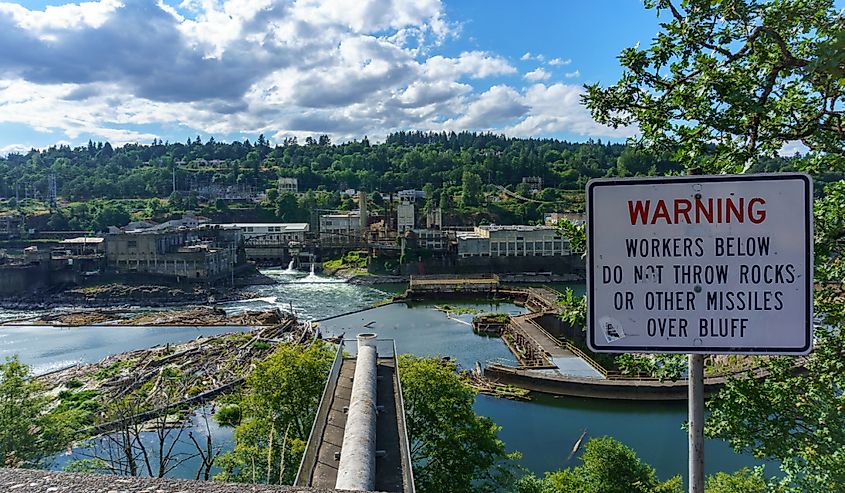 View of Willamette Falls and industrial area warning sign in Oregon City, Oregon