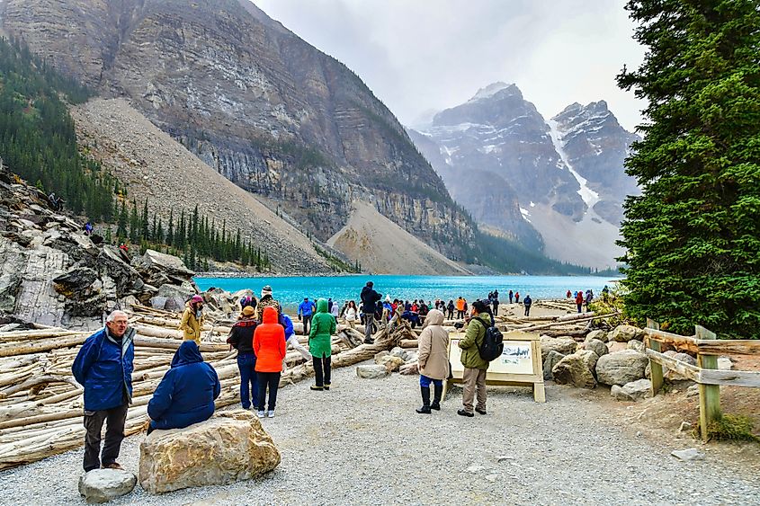 Tourists enjoying views of the Moraine Lake in Banff National Park, Alberta, Canada