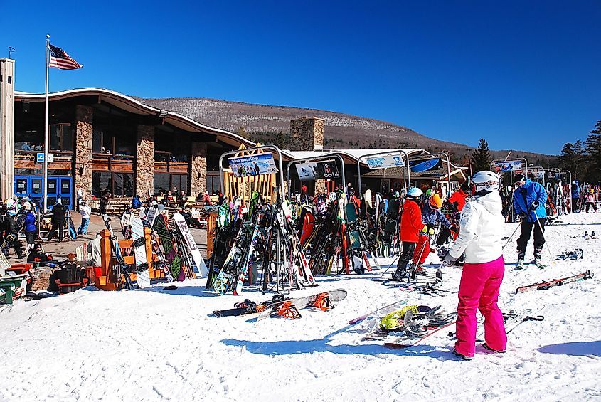 A young woman takes off her skiing gear for a midday break at a ski resort in Hunter, New York