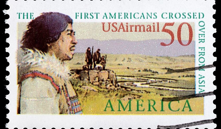 A stamp printed in USA showing first Americans crossed over from Asia and the Bering land bridge