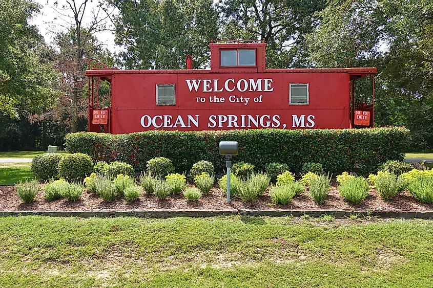 A caboose located on the side of Highway-90 proudly displays the city's sign of welcome