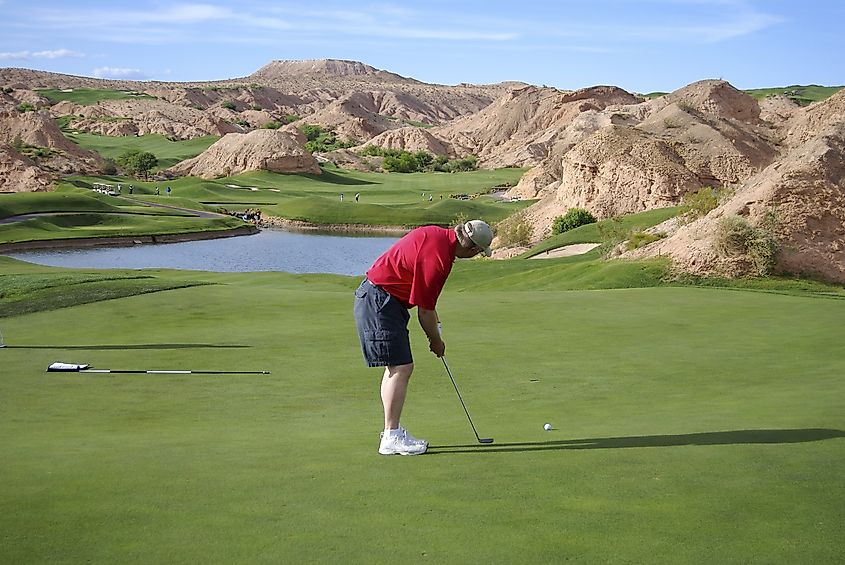 Man putting on beautiful golf course (Wolf Creek Golf Course in Mesquite, Nevada).