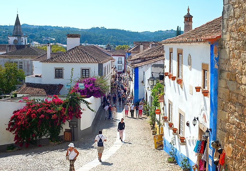 People walking by the Old Town street of Obidos, Portugal