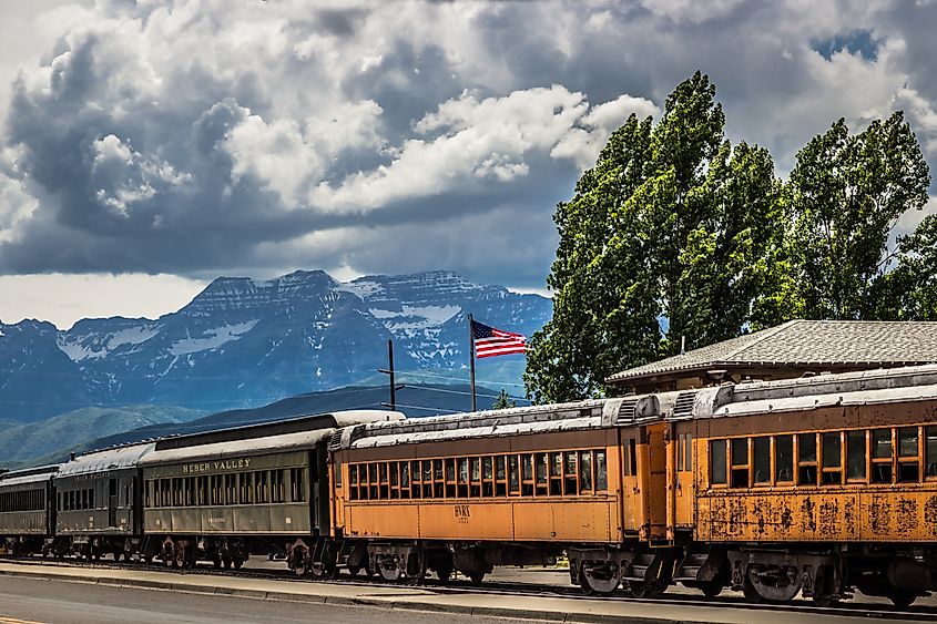 Vintage passenger cars line the tracks at the historic Heber Valley Railroad Station in Utah. 