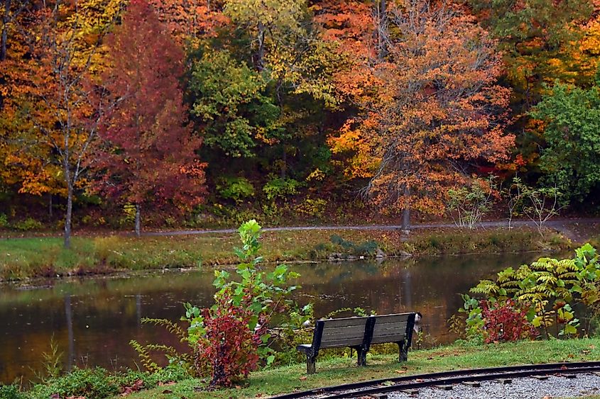 Park bench sits besides Steele Creek Lake, in Steele Creek Park, Bristol, Tennessee