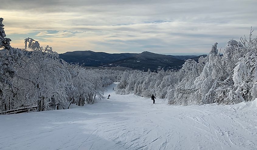 Snowy mountaintop in Manchester, VT. Skier can be seen in frame.
