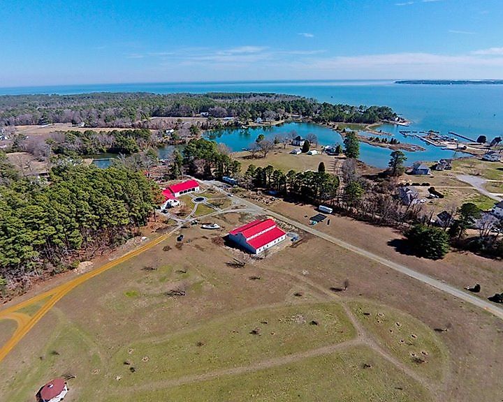 Aerial image of the Deltaville Maritime Museum, Deltaville, Virginia, looking out over Jackson Creek and the Chesapeake Bay.