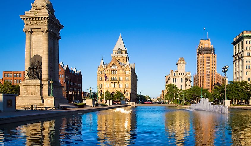 Downtown Syracuse New York with view of historic buildings and fountain at Clinton Square.