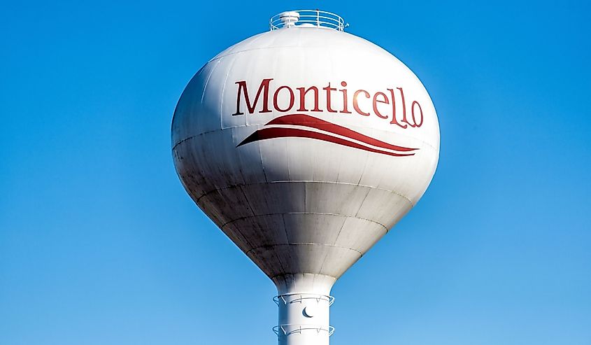 View of water tower sign for Monticello in Illinois countryside 