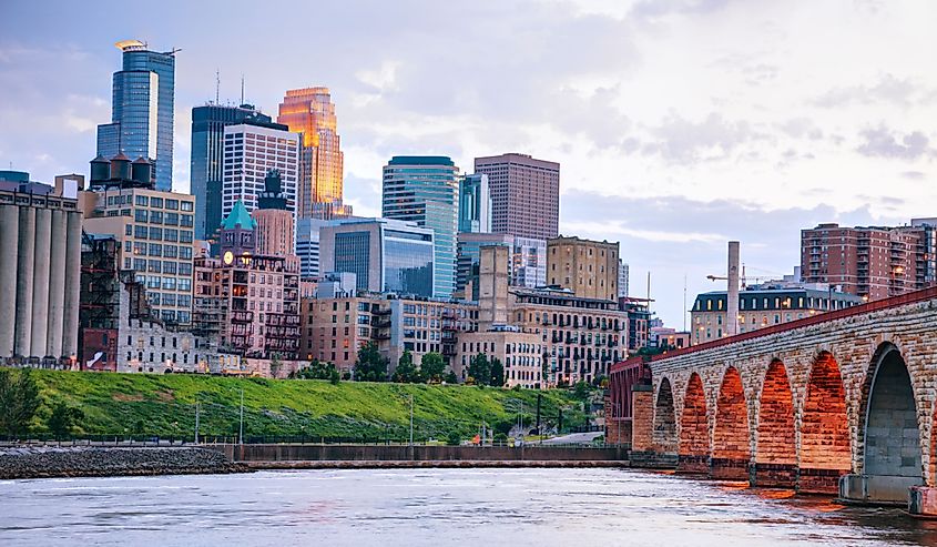 Downtown Minneapolis skyline, Minnesota at night time as seen from the famous stone arch bridge