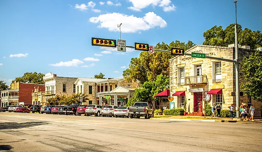 The Main Street in Fredericksburg, Texas, also known as "The Magic Mile," with retail stores and people walking.