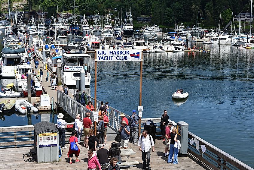 People enjoy the Classic Yacht Festival Tour on Gig Harbor, Washington, via july7th / IStock.com