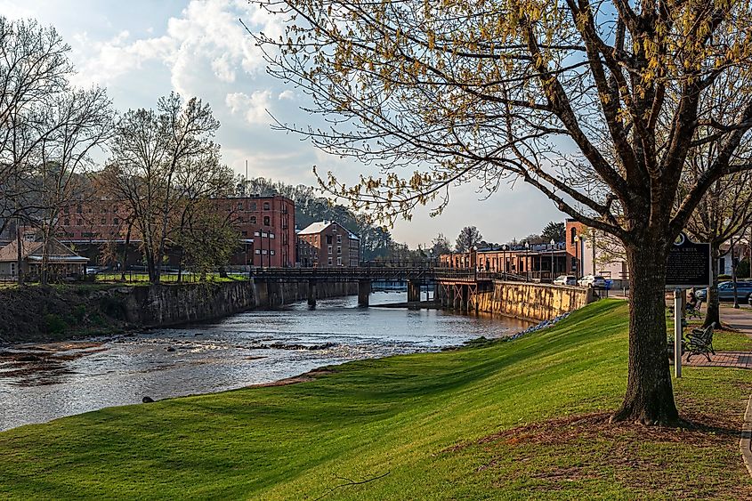 Scenic view of Autauga Creek and the Daniel Pratt cotton gin mill complex in downtown Prattville, Alabama, as seen from the Creekwalk on a clear spring day.