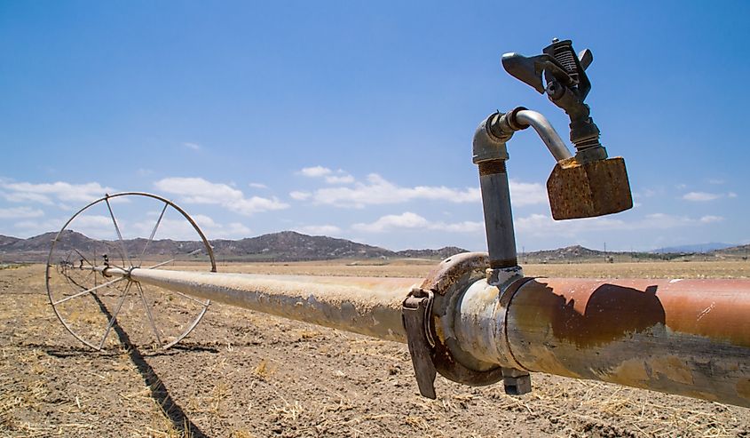 The water irrigation pipes in the dry Southern California farmland.