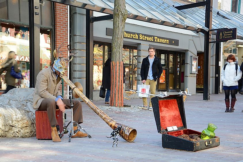 Street Artist playing African Horn at Church Street Marketplace in downtown Burlington, Vermont