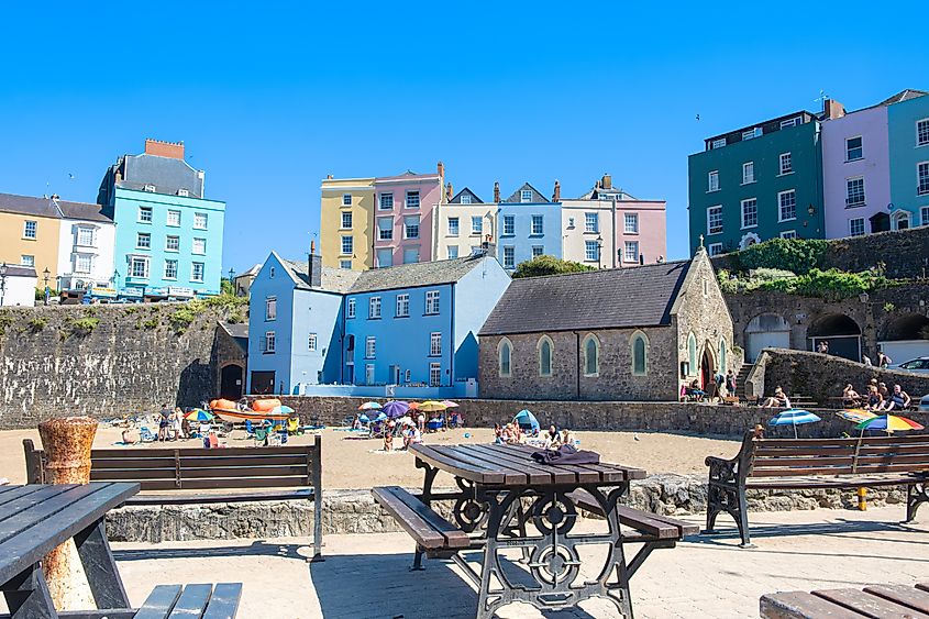 Colorful homes and waterfront benches in Tenby, Wales, the UK.