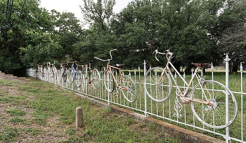 Bicycles along the fenceline as art in Salado, Texas