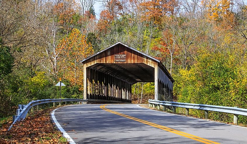 The picturesque Corwin M. Nixon covered bridge over the Little Miami River on an autumn day at Waynesville, Ohio, USA