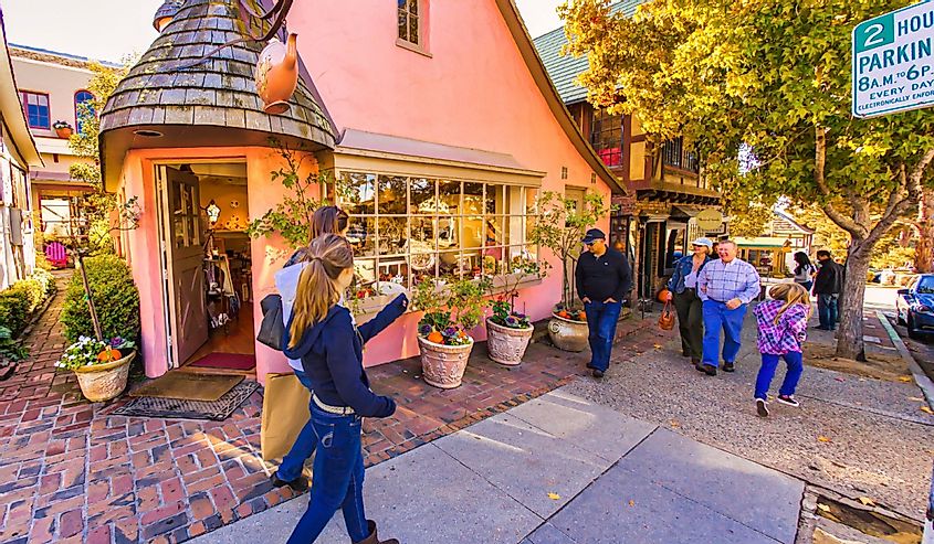 people shopping on main street of Carmel-by-the-Sea with luxurious expensive boutiques all around
