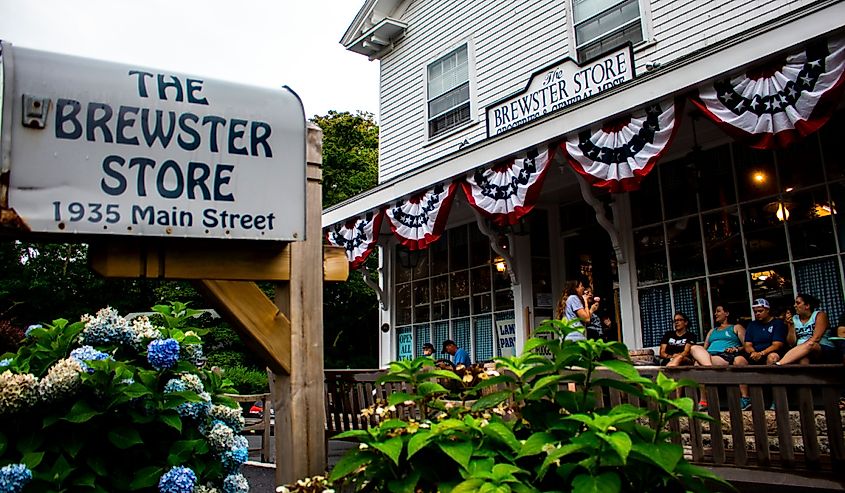 The iconic Brewster Store with the metal mail box in the foreground and the storefront with patrons enjoying ice cream on the deck in the background.