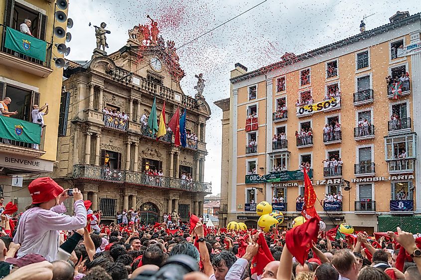 A packed, red and white-clad town square celebrates the annual San Fermin festival in Pamplona, Spain