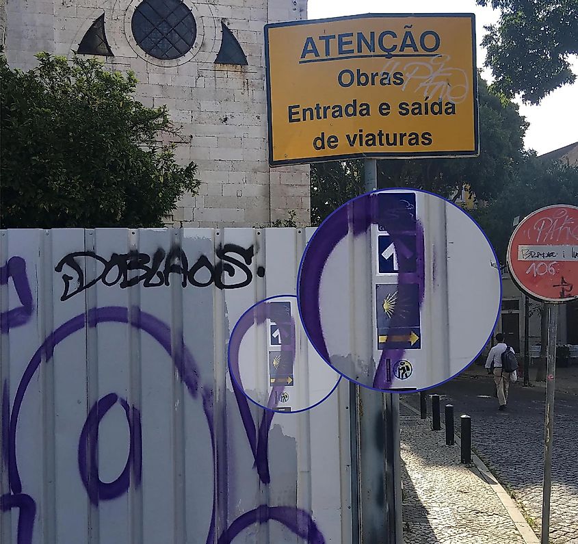 The first arrow of the Camino Portugues, obscured by graffiti, at the Se Cathedral in Lisbon