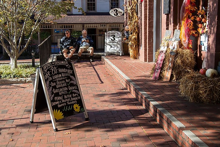 Dahlonega, Georgia – October 26, 2021: Outdoor decorations with a seasonal harvest theme make an inviting entrance to a gift shop in the downtown historic district in Dahlonega, Georgia.
