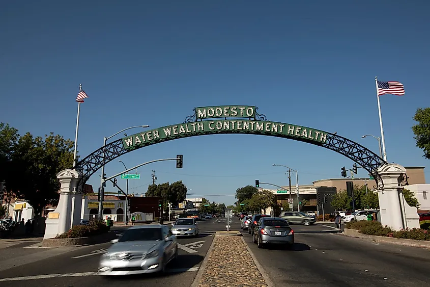 Daytime view of the historic 1912 Modesto Arch as it spans over I Street through downtown Modesto