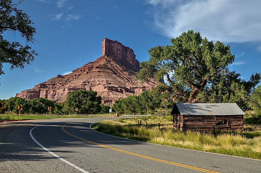 The Palisade butte rising over desert cliffs and mesas as seen from the Unaweep Tabeguache Scenic Byway near Gateway in Mesa County, Colorado